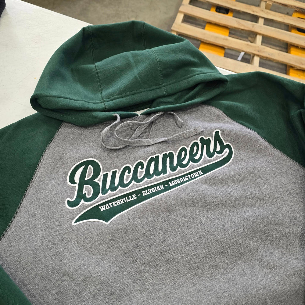 Green and gray hoodie with 'Buccaneers' logo on a wooden pallet.