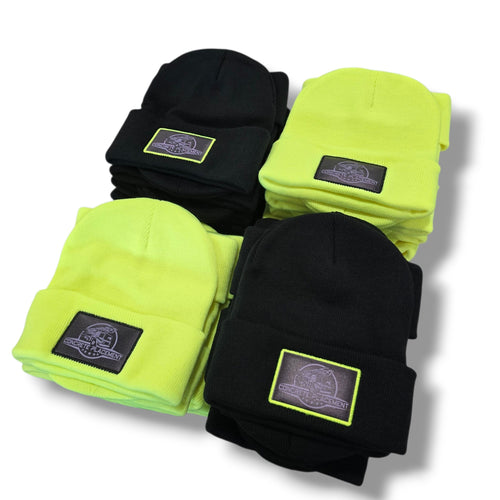 Four folded stocking caps, two black and two neon green, with brand labels on a white background.